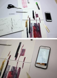 papier découpé, carnet et téléphone posés sur une table